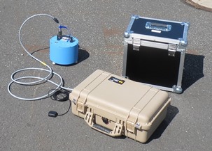 Seismische Messstation im Test: im beigen Case befinden sich die Datenlogger und Stromversorgung, der Sensor in blau (Seismometer Lennartz 3D-5s) misst die Bodenschwingungen. Links neben dem Case ist die GPS-Antenne in schwarz zu erkennen. Seismische Messstation im Test: im beigen Case befinden sich die Datenlogger und Stromversorgung, der Sensor in blau (Seismometer Lennartz 3D-5s) misst die Bodenschwingungen. Links neben dem Case ist die GPS-Antenne in schwarz zu erkennen.